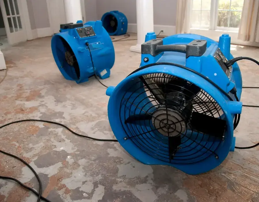 A high-volume air mover running on a floor in a northeast Valley home