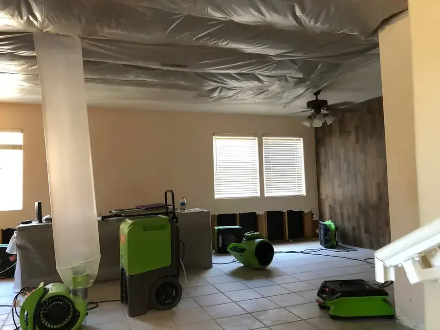 Baseboards removed to dry a soaked wall in a northeast Valley home