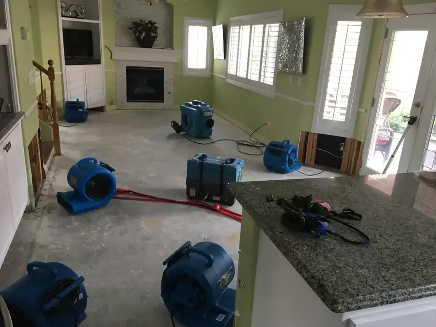 Air movers and a dehumidifier drying a water damaged Paradise Valley living room
