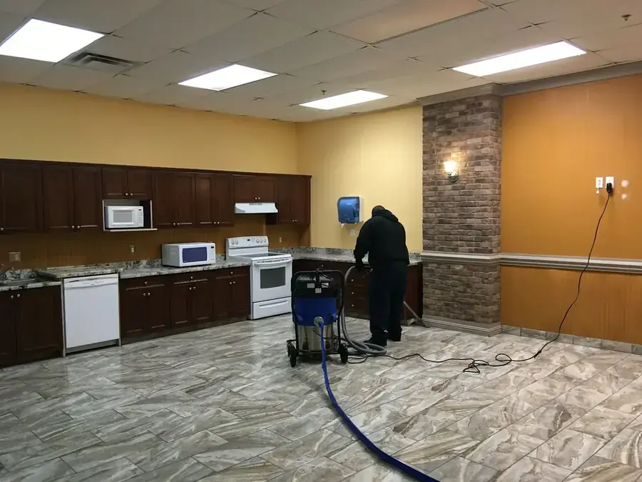 Technician extracting standing water from a Paradise Valley tile floor